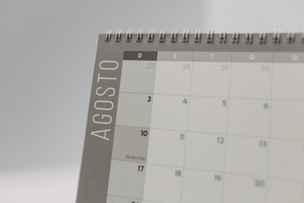 Close-up of a spiral-bound calendar highlighting August dates.